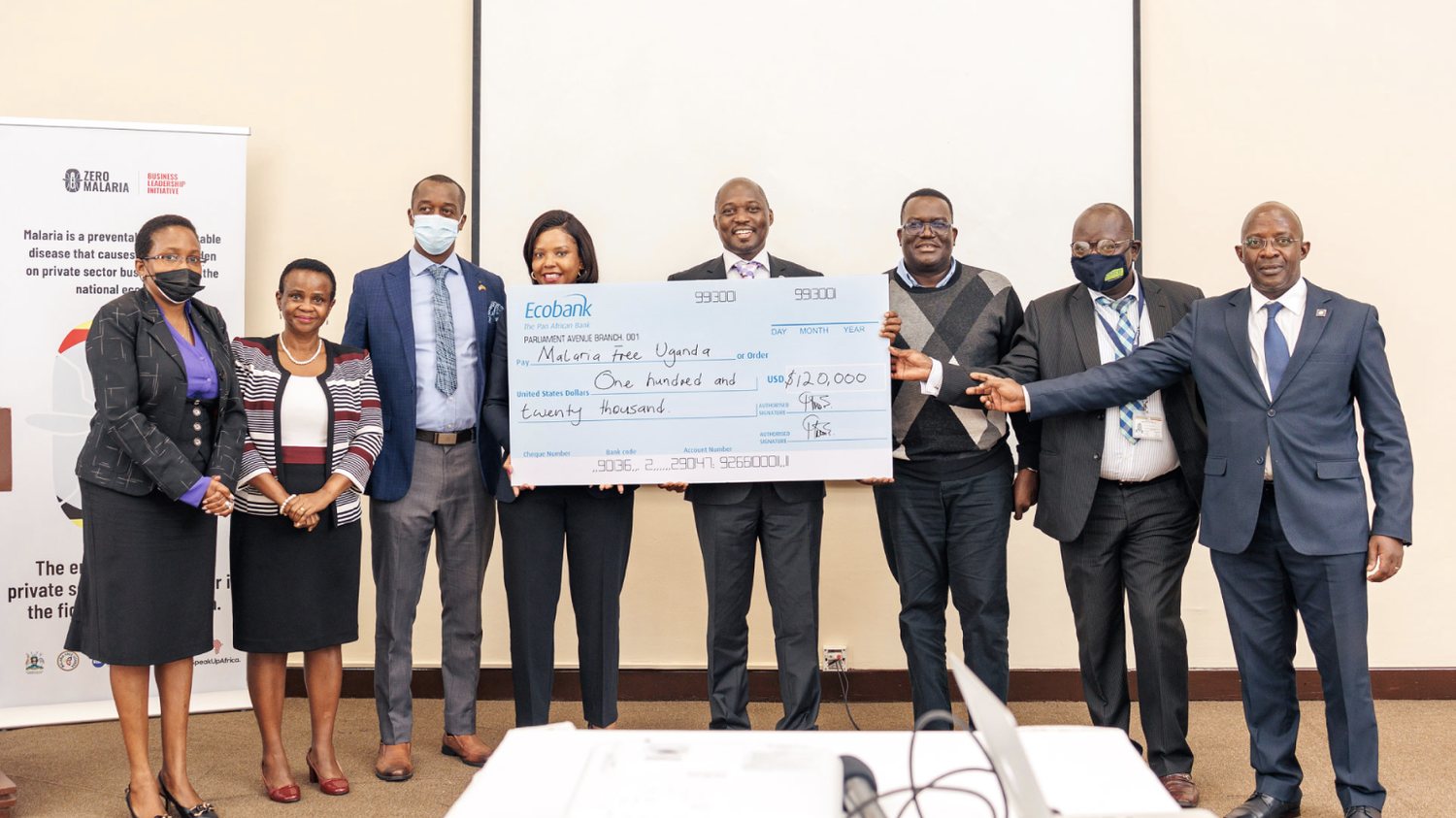 Ecobank Uganda and Malaria Free Uganda representatives hold a 120,000 US dollar cheque made out to Malaria Free Uganda