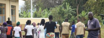 Community members, MYCU and Ministry of Health team gathered outdoors at Nalugai Health Centre III